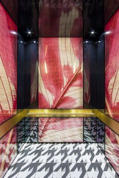 an artisticly designed bathroom with black and white checkered flooring on the walls