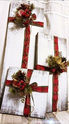 three wrapped christmas gifts sitting on top of a table