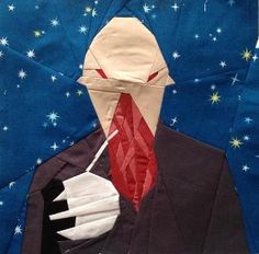 a man in a suit and tie has his face made out of paper