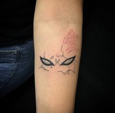 a woman's arm with a tattoo on it that has an evil looking face