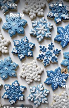 snowflake cookies are displayed on a white surface with blue and white icing