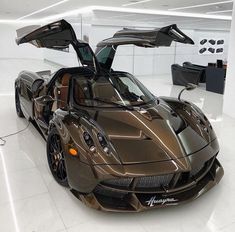 a brown sports car parked in a showroom