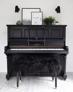 a black piano with a bench underneath it