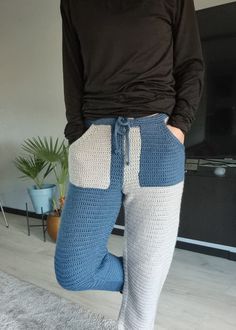 a person standing in front of a tv wearing blue and white knitted leggings