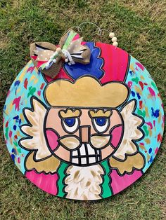 a painted frisbee on the ground with a bow around it's neck