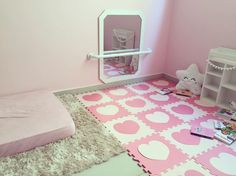 a bedroom with pink walls and carpeted flooring in the shape of heart shapes