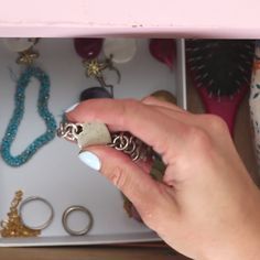 a person holding some rings in their hand and looking at the ring on her finger