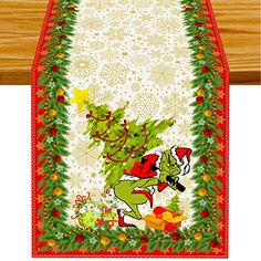 a christmas table runner with an image of the grin and santa clause on it's back