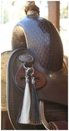 a horse saddle with a tassel on it