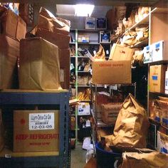 there are many boxes and bags on the shelves