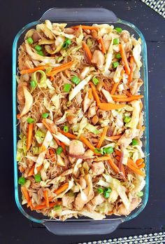 a casserole dish with shredded carrots, meat and veggies in it