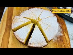 a cake that is sitting on top of a wooden cutting board with slices cut out