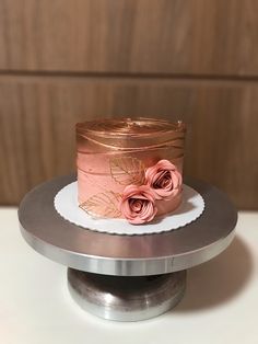 there is a cake that has been decorated with pink flowers on the top of it