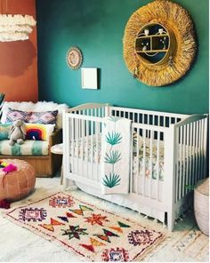 a baby's room with green walls and white crib