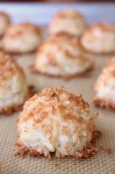 coconut macaroni and cheese balls are on a baking sheet, ready to be eaten