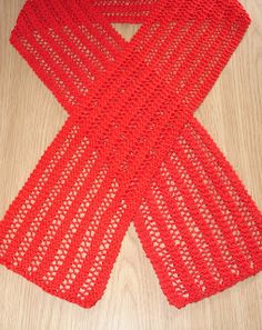 a red scarf sitting on top of a wooden table