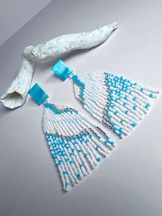 Add a touch of elegance and style to your outfit with our Delica beaded white silver turquoise fringe earrings. Handmade with care and attention to detail, these earrings are lightweight and comfortable to wear all day long. The unique combination of white, silver, and turquoise beads make these earrings a rare find that will surely make you stand out. Elevate your look with these trendy and chic earrings that are perfect for any occasion. Beads may vary slightly in color due to the color settin Elegant Turquoise Beaded Fringe Earrings, Turquoise Beaded Fringe Drop Earrings, Turquoise Fringe Beaded Drop Earrings, Turquoise Beaded Fringe Tassel Earrings For Summer, Elegant Turquoise Beaded Earrings With Fringe, Elegant Turquoise Earrings With Fringe, Turquoise Earrings With Beaded Fringe, Turquoise Earrings With Beaded Fringe For Beach, White Beaded Fringe Tassel Earrings For Beach