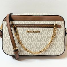 Price Is Firm New With Tag Michael Kors Jet Set Item East West Chain Crossbody Shoulder Bag Mk Signature Pvc Leather Vanilla Brown 100% Authentic Retail: $348.00 Plus Tax *Please See The Measurement For The Size* No Dusk Bag Zip Top Closure Michael Kors Logo At Front Pvc Leather Gold Toned Hardware Custom Fabric Lining 2 Slip-In Pockets 10" (L) X 6"(H) X 2.5"(D) Strap: 20"-23" Very Clean, Smoke-Free And Pet-Free Environment. Michael Kors White Shoulder Bag With Chain Strap, Michael Kors Logo, East West, Kors Jet Set, Zip Top, Michael Kors Jet Set, Jet Set, Michael Kors Bag, Crossbody Shoulder Bag