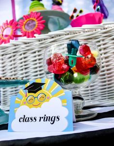 there is a glass ring with candy in it on the table next to other items