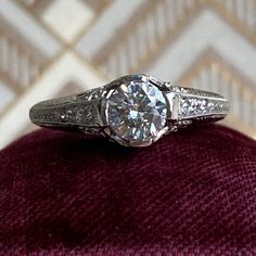 a diamond ring sitting on top of a velvet cushion