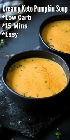 two black bowls filled with creamy pumpkin soup