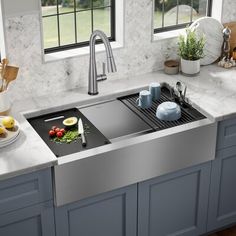 a stainless steel kitchen sink with cutting board and knifes on the counter top next to it