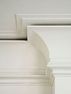 the corner of a room with white paint and molding