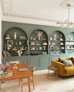 a living room filled with furniture and shelves