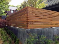 a wooden fence in front of a house