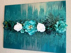 a painting with flowers on it hanging on the wall