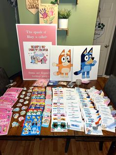 the table is full of cards and posters for children's birthdays or special occasions