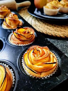 some cupcakes are sitting in a muffin tin