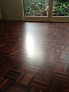 an empty room with wood flooring and sliding glass doors