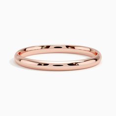 a rose gold wedding ring on a white background