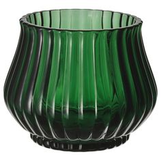 a green glass vase sitting on top of a table