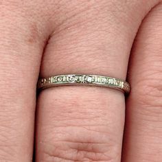 a woman's hand with a wedding ring on it