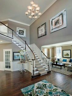 a living room filled with furniture and a stair case