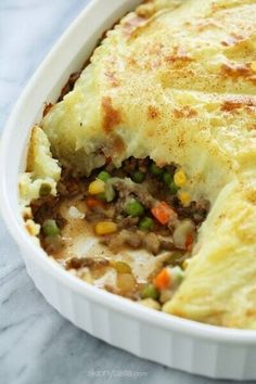 a casserole dish filled with meat and vegetables