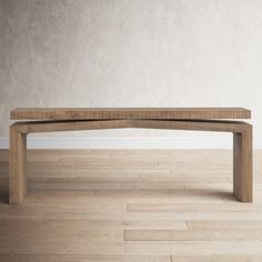 a wooden bench sitting on top of a hard wood floor next to a white wall