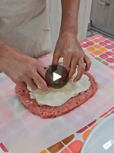 a man is kneading some food on top of a table