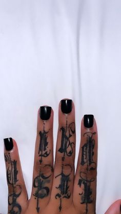 a woman's hand with tattoos on it