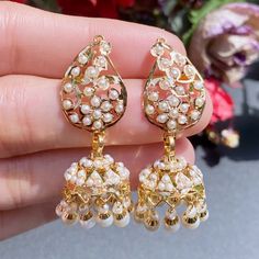 Featuring a handcrafted 22 carat gold necklace with jhumki earrings. This necklace features a traditional design of mango motifs inspired from the Mughal Era of jewellery. The necklace weighs 25.36 gms including 0.75gms in the pearl drops. The jhumki earrings weigh 13.59gms including 1.94 grams in the hanging pearl beads 22k Gold Jewelry Necklaces, 22k Gold Jewelry, Jhumki Earrings, Pearl Necklace Set, 22 Carat Gold, Jewelry Pearl, Gold Jewelry Necklace, Emerald Necklace, Indo Western