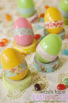 several colorful easter eggs sitting on top of a table