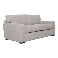 a light gray couch sitting on top of a white floor