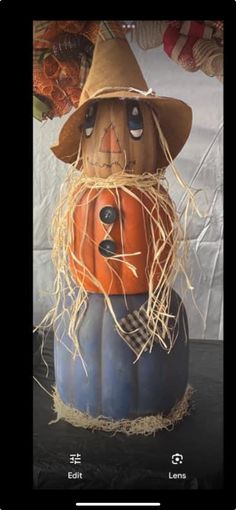 a pumpkin with a scarecrow on it's head