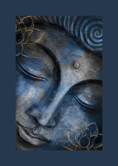 the face of a buddha statue with blue and silver paint on it's face