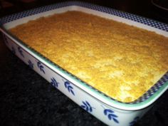 a casserole dish filled with food sitting on top of a counter next to a stove