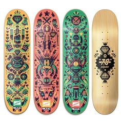 three skateboards with different designs on them