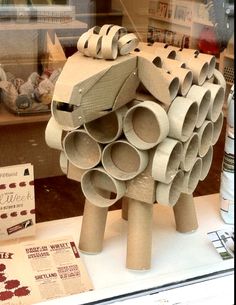 there is a sculpture made out of toilet paper on display in the shop front window