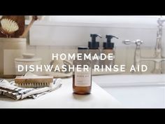 a bottle of dishwasher rinse aid sitting on top of a bathroom counter